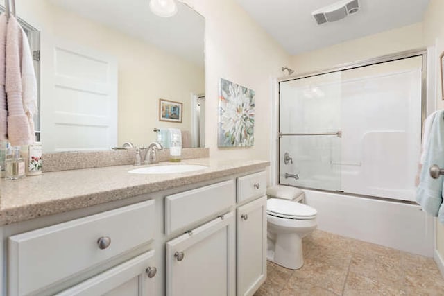 full bathroom featuring bath / shower combo with glass door, vanity, and toilet