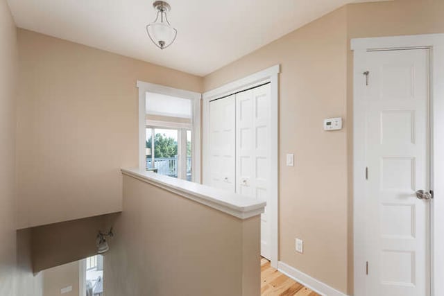 hallway with light hardwood / wood-style flooring