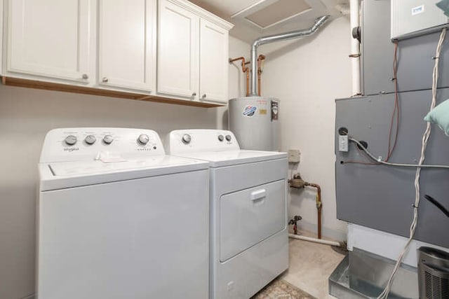 washroom with water heater, cabinets, and independent washer and dryer