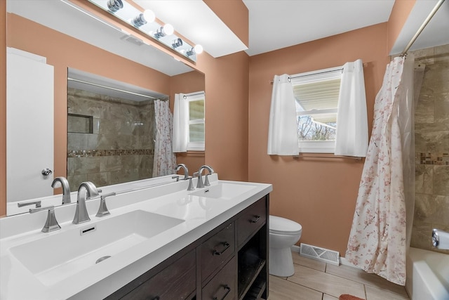 full bathroom with vanity, shower / bath combo, and toilet