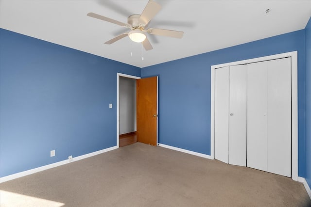 unfurnished bedroom with carpet floors, ceiling fan, and a closet