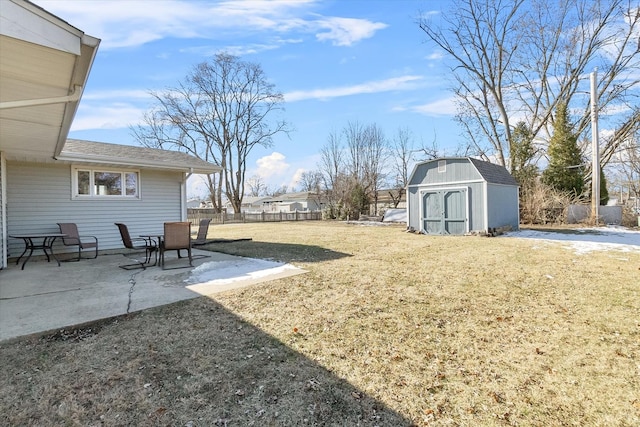 view of yard with a storage unit and a patio