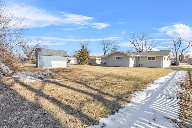 rear view of property featuring an outbuilding and a yard