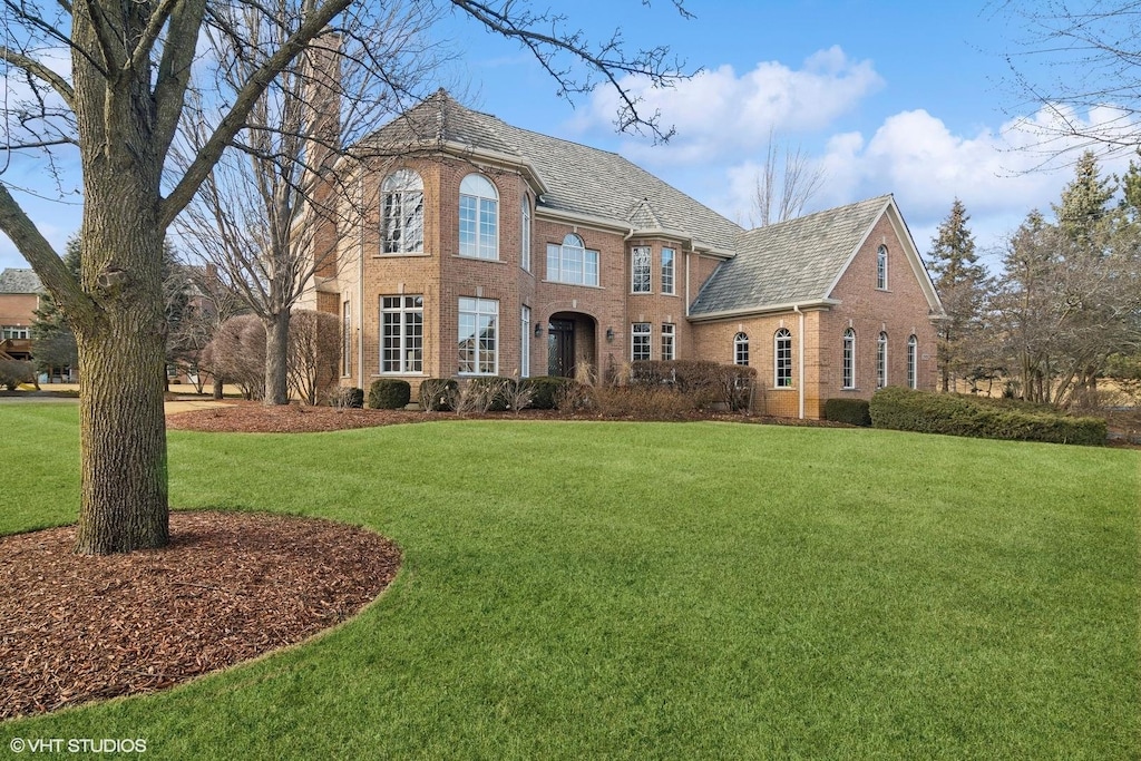 21928 N Tall Oaks Ct, Kildeer, IL 60047 - view of front of house featuring a chimney, a front lawn, and brick siding