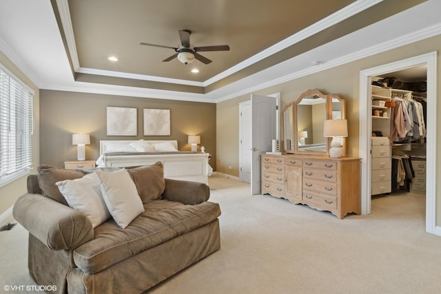 bedroom with crown molding, recessed lighting, a raised ceiling, a spacious closet, and light carpet