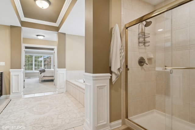 bathroom featuring ornate columns, a shower stall, ornamental molding, and a bath