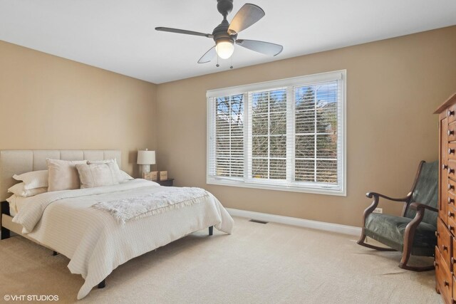 bedroom featuring a ceiling fan, carpet, visible vents, and baseboards