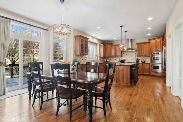 dining area with wood finished floors and recessed lighting