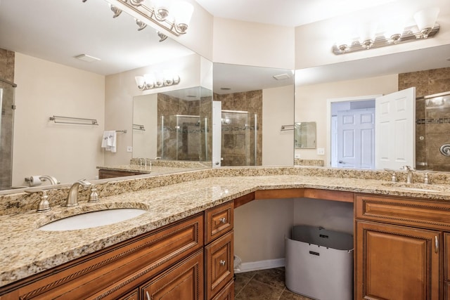 bathroom featuring vanity, a shower with shower door, and tile patterned floors