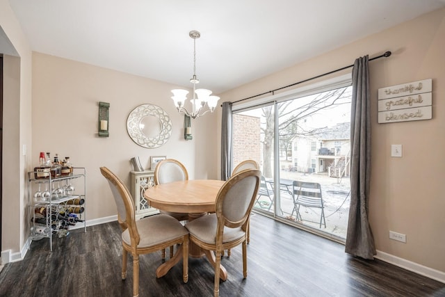 dining space with a chandelier and dark hardwood / wood-style flooring