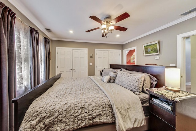bedroom with crown molding, visible vents, multiple closets, and recessed lighting