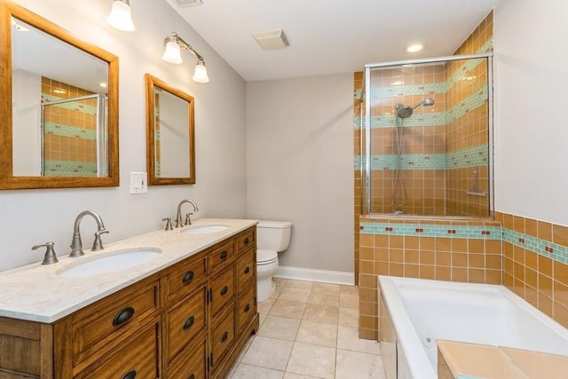 bathroom featuring toilet, tiled shower, and a sink