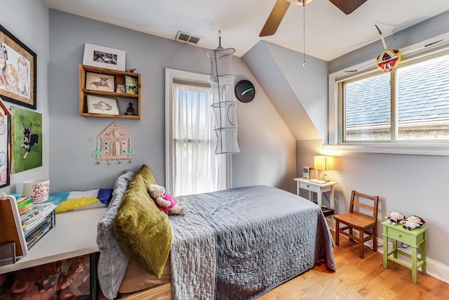 bedroom with visible vents, ceiling fan, and wood finished floors