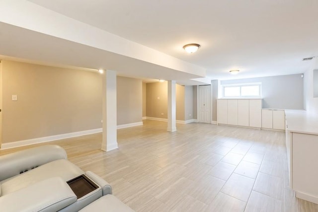 basement with visible vents and baseboards