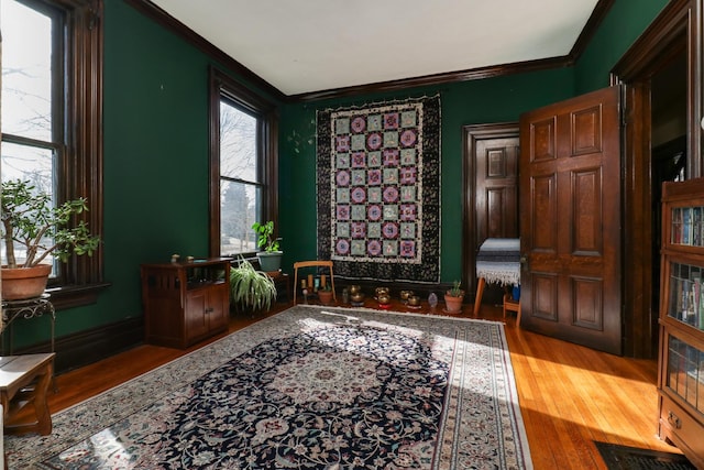 sitting room featuring crown molding and wood-type flooring