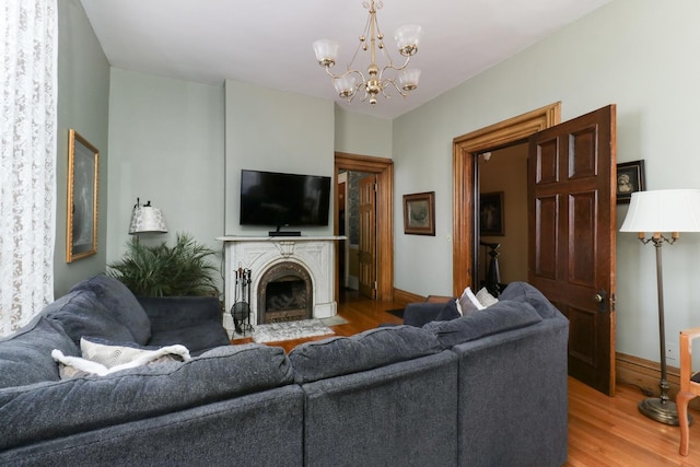 living room with hardwood / wood-style flooring and an inviting chandelier