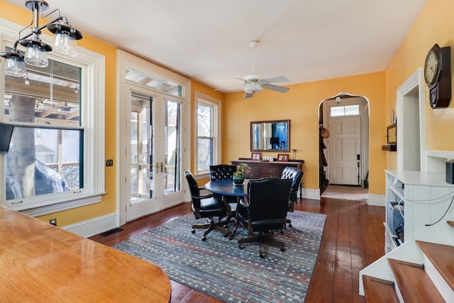 dining room with dark wood-type flooring, ceiling fan, and french doors