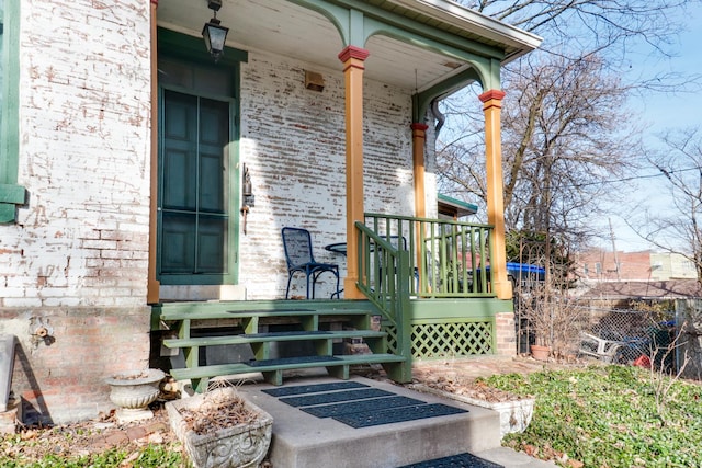 view of exterior entry with a porch