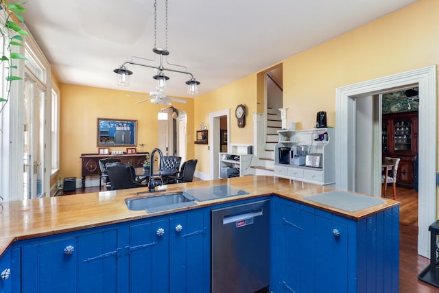 kitchen with wood counters, blue cabinets, and dark hardwood / wood-style floors