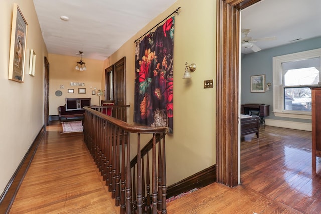 hallway with light hardwood / wood-style floors