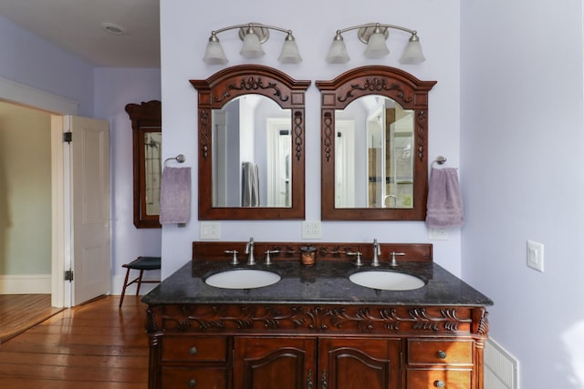 bathroom with vanity and wood-type flooring