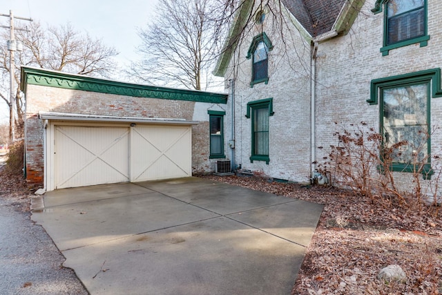 view of front of property featuring a garage and central AC unit