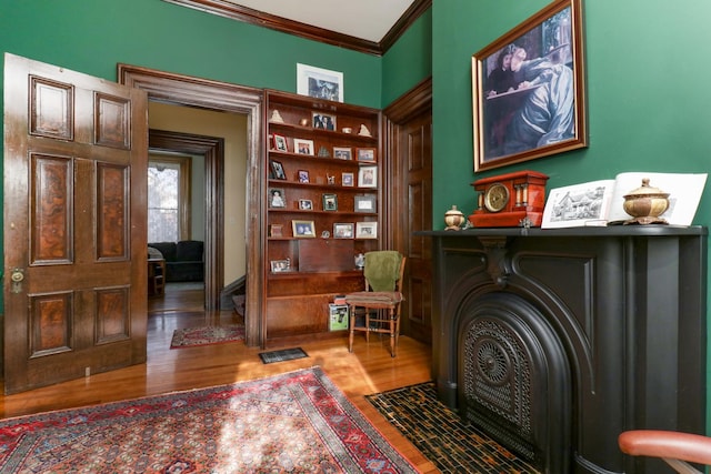 sitting room featuring crown molding and wood-type flooring