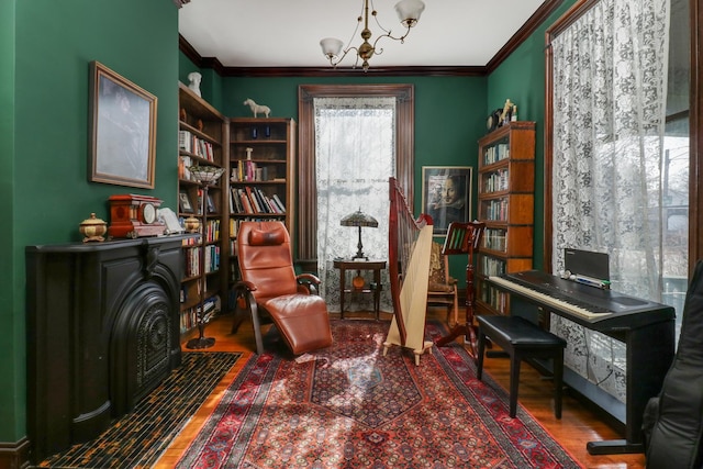 office area featuring a notable chandelier, hardwood / wood-style flooring, and ornamental molding