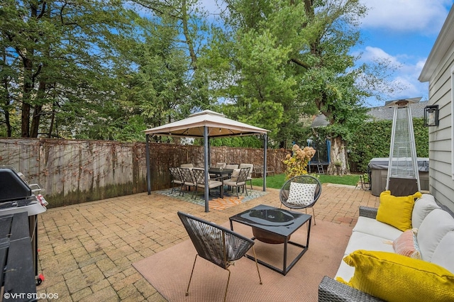 view of patio featuring grilling area and an outdoor living space with a fire pit