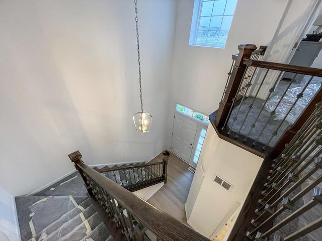 stairs featuring a healthy amount of sunlight and a high ceiling