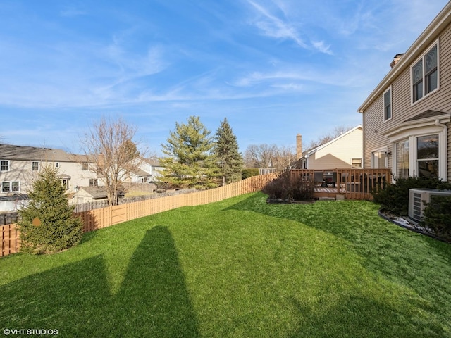 view of yard with central AC and a wooden deck