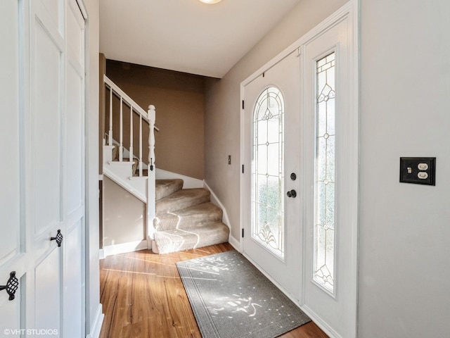 foyer entrance with light hardwood / wood-style floors