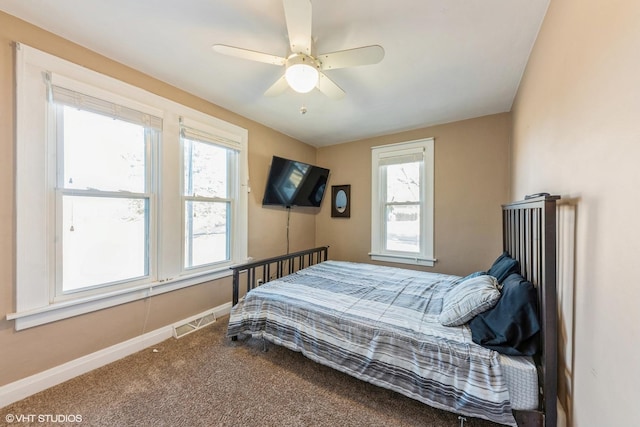 bedroom with baseboards, multiple windows, visible vents, and carpet flooring