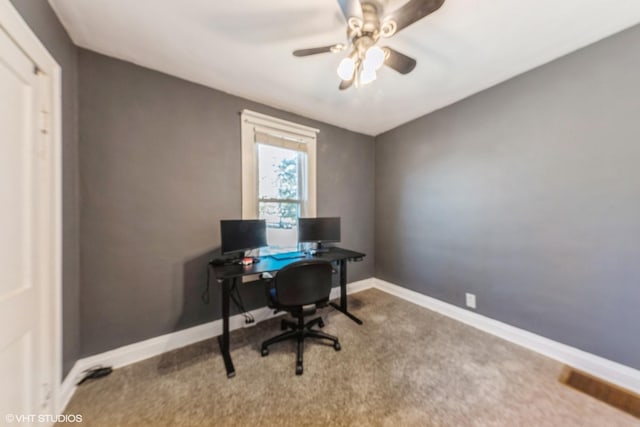 carpeted office space featuring visible vents, baseboards, and a ceiling fan