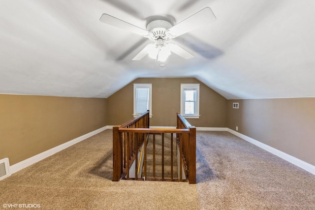 additional living space featuring carpet floors, lofted ceiling, and baseboards