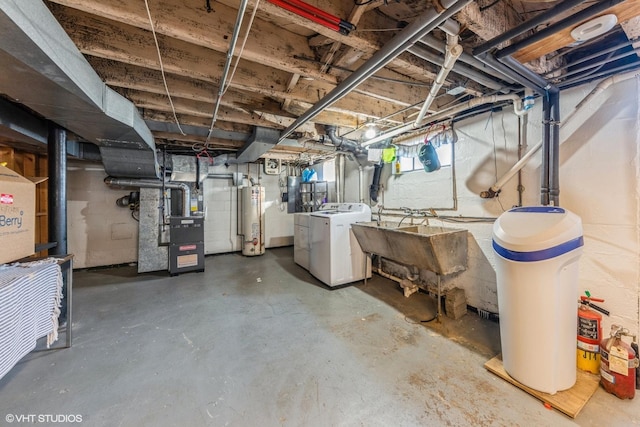 below grade area featuring washer / clothes dryer, gas water heater, a sink, and heating unit