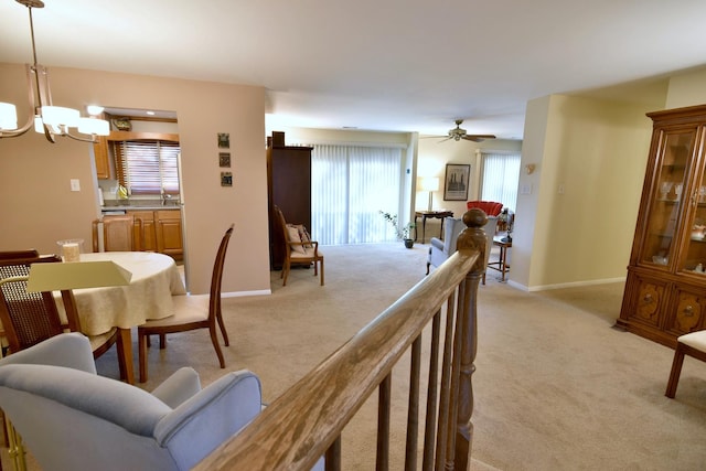 carpeted living room with a notable chandelier