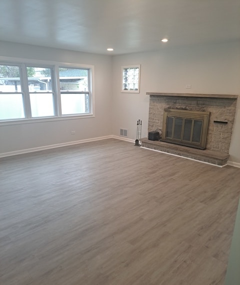 unfurnished living room featuring hardwood / wood-style flooring