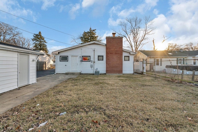 rear view of house with a lawn and central air condition unit