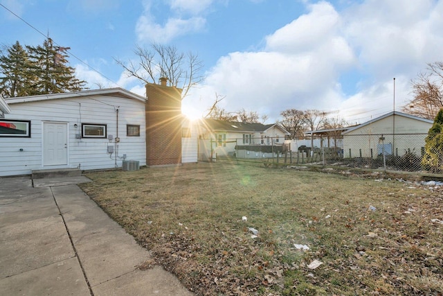 exterior space featuring central air condition unit, a patio, and a lawn