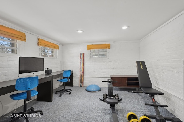 carpeted office space with brick wall and ornamental molding