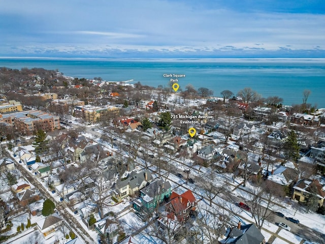 snowy aerial view featuring a water view