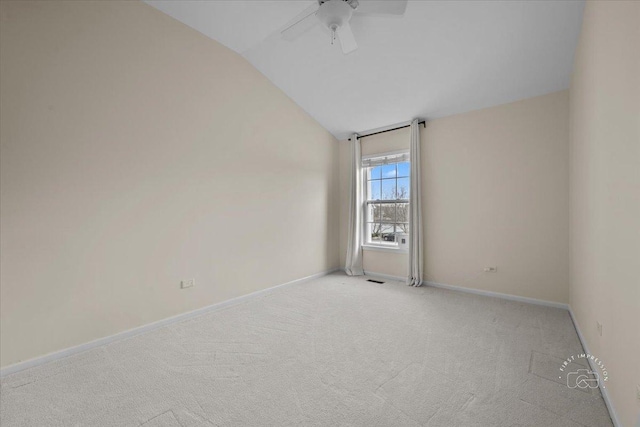 unfurnished room with lofted ceiling, ceiling fan, light carpet, and baseboards