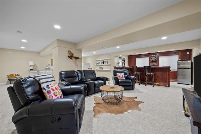 living room featuring recessed lighting, baseboards, light colored carpet, and a bar