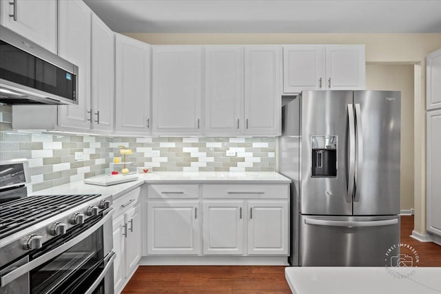 kitchen featuring white cabinetry, appliances with stainless steel finishes, decorative backsplash, and light stone counters