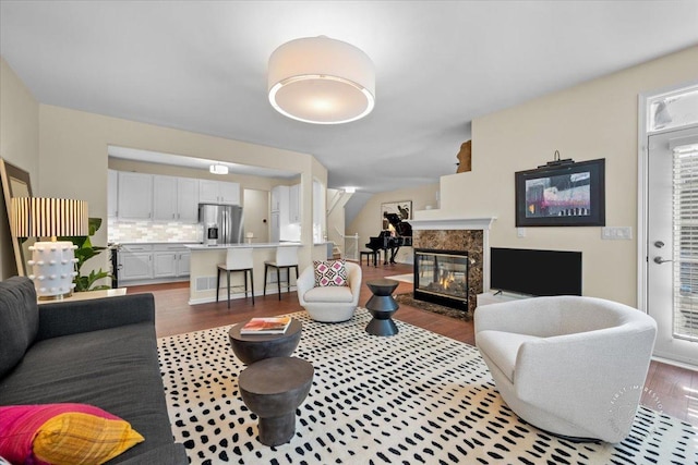 living room featuring wood finished floors and a premium fireplace