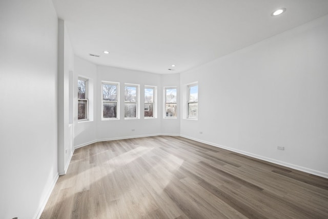 unfurnished room with light hardwood / wood-style flooring