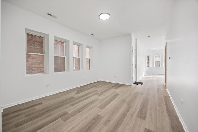 empty room with light hardwood / wood-style floors