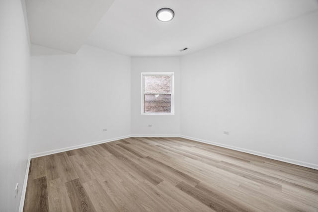 spare room featuring light wood-type flooring