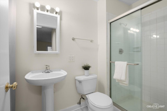 bathroom featuring walk in shower and toilet